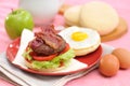 Beef bacon burger with eggs and vegetables for breakfast Royalty Free Stock Photo